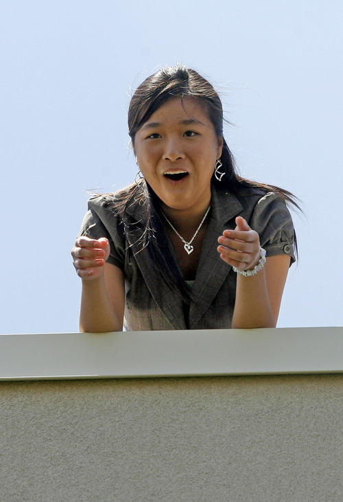 Rick Egan  | The Salt Lake Tribune 

Cindy Giang reacts as her watermelon bursts open after she dropped it from the roof of Copper Hills High, Friday, July 6, 2012.  Students built devices in an attempt to catch watermelons that were dropped from the roof Students of their school as part of a science and physics grant the school received.