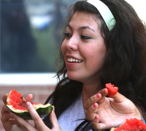 Rick Egan  | The Salt Lake Tribune
Steffi Falla eats one of the melons that bursted open as it was dropped from the roof of Copper Hills High. Students built devices in an attempt to catch watermelons dropped from the roof of their school as part of a science and physics grant the school received.