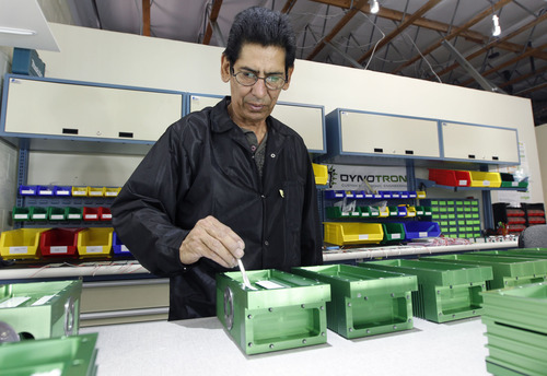 Al Hartmann  |  The Salt Lake Tribune
Gerald Padilla, techincial supervisor at Dynotron works on assembling 96 LED 