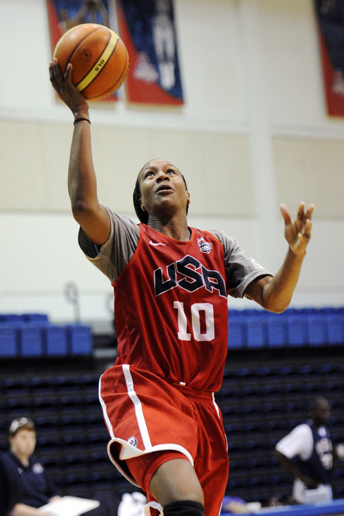 FILE-- July 15, 2012 file photo United States women's Olympic basketball player Tamika Catchings drives to the basket during practice in Washington.  Catchings is one of six players on the U.S. women's Olympic team who have played in Turkey. (AP Photo/Nick Wass)