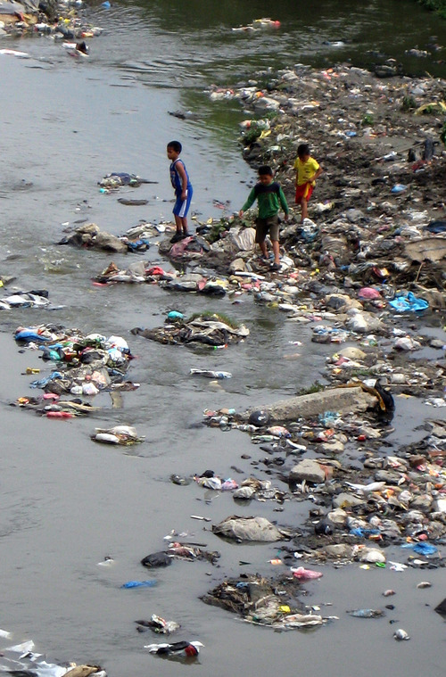 Tony Semerad | The Salt Lake Tribune

Children play along a garbage-clogged stretch of the heavily polluted Bishnumati River flowing through Nepal's capital, Kathmandu. Rapid urbanization in Nepal has contributed to rivers such as the Bishnumati, Bagmati, Tukucha and Manchara being transformed from free-flowing sources of drinking water to heavily polluted dumps for the city's trash and sewage. Thousands of impoverished rural residents have moved to Kathmandu over the last decade, census number show, a trend partly driven by weather-related declines in rural agriculture attributed to climate change.  Temperatures in the central Asian nation are rising by about one-tenth of a degree yearly, local and national experts say, and a dramatic drop in winter precipitation is pushing the country toward drought. The lack of water and glacial melting has affected river flows, creating problems with Nepal's hydroelectric power generation. Outages, known as load shedding, are common throughout the capital.