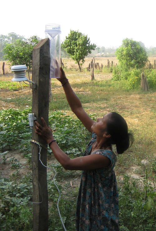 Tony Semerad  |  The Salt Lake Tribune

Gita Chaudhary adjusts the rain guage on a sophisticated weather sensor located on her farm village near Ramsikhar Jhala, Nepal. The high-tech unit records precipitation and temperature data and is one of 30 such meteorology stations spread across Kailali and Bajura districts in western Nepal, part of a climate-change study involving climatologists and farm experts at Utah State University. Chaudhary plays a key role in her village development committee, and is typical of young rural women participating in the U.S.-funded study, as she is considered influential in her local community and progressive for her willingness to adopt new, drought-hardy farming techniques.