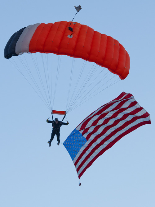 Michael Mangum  |  Special to the Tribune

A skydiver with an American flag approaches a landing in the West Jordan Arena at the beginning of Merrill Osmond's Youth Pioneer Pageant in West Jordan on Monday, July 23, 2012.