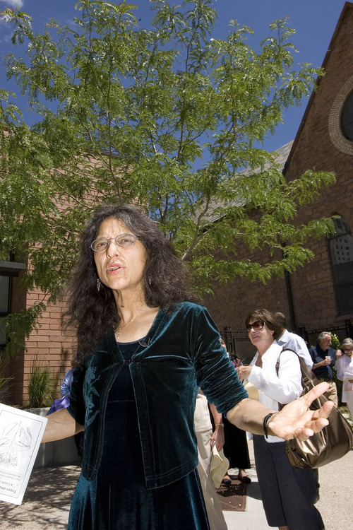Paul Fraughton | The Salt Lake Tribune
University of Utah scientist Nalini Nadkarni directs a recent tour of the trees at the Cathedral Church of Saint Mark. She passed out a guide book to people attending her lecture, pointing out the names of the trees planted around the cathedral as well as religious references to trees.