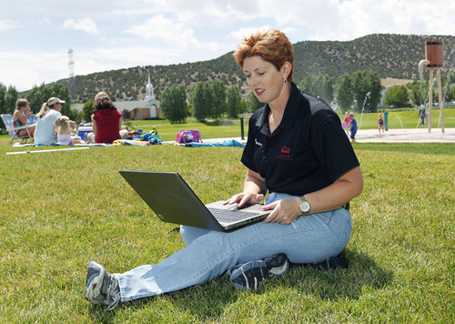 Al Hartmann  |  The Salt Lake Tribune	
Mayor Heather Jackson works on her laptop sitting in the grass in Nolan Park at Eagle Mountain.    The city is planning to be the first in Utah to get citywide wifi. The local internet provider DirectComm is outfitting the town with access towers so subscribers can get wifi access anywhere in Eagle Mountain.