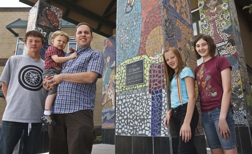 Leah Hogsten  |  The Salt Lake Tribune
Over 60 students from North Davis Preparatory Academy including students, from left: Tyler Hammond, Lexie Bazzano, Andra Emmertson and mosaic artist Roger Whiting (holding son Wesley, 2) worked for 5 months to design a mosaic for the entrance columns to their school in Layton.