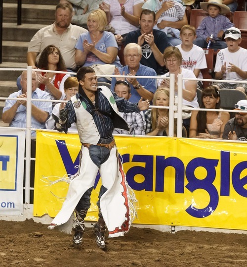 Trent Nelson  |  The Salt Lake Tribune
Caleb Bennett celebrates his ride in the Bareback Riding competition at the Days of '47 Rodeo at the Maverik Center in West Valley City, Utah on Tuesday, July 24, 2012.