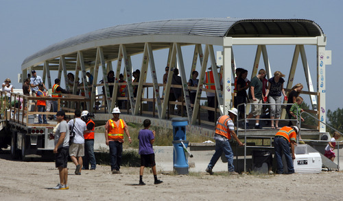 Francisco Kjolseth  |  The Salt Lake Tribune
The Utah Department of Transportation enlisted community members Thursday to help decorate a pedestrian bridge it's recycling. Residents -- including lots of children -- joined in handprint paiting the skywalk, which in coming weeks will be moved into place at 8200 S. and U-111.