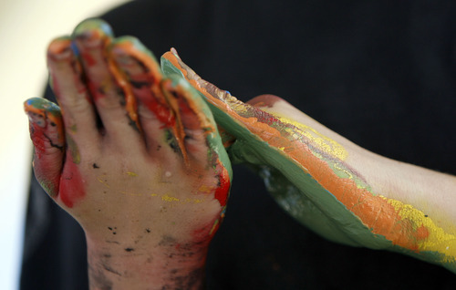 Francisco Kjolseth  |  The Salt Lake Tribune
Liberty Patterson, 12, ends up with rainbow-colored hands as UDOT invites people to join in handprint painting for a pedestrian bridge it plans to place at 8200 South and U-111.