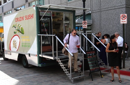 Rick Egan  | The Salt Lake Tribune 

THe Cruzin' Sushi food truck serves customers,  on Food Truck Thursday, at the Gallivan Plaza, Thursday, July 19, 2012.