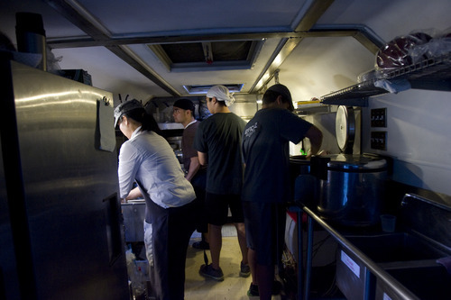 Kim Raff | The Salt Lake Tribune
Katsu Yamazaki works in the kitchen of the Bento Truck during the Twilight Concert Series at Pioneer Park in Salt Lake City on July 19, 2012.