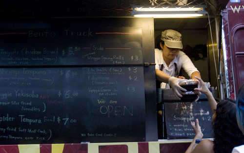 Kim Raff | The Salt Lake Tribune
Tokiko Yamazaki gives an order to a customer at the Bento Truck during the Twilight Concert Series at Pioneer Park in Salt Lake City on July 19, 2012.