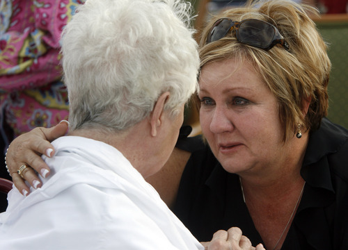 Rick Egan  | The Salt Lake Tribune 

Julie Jones Hansen comforts her mother Donna Monson, outside the Legacy Village care center Monday, July 30, 2012.
Hansen drove from her home in South Jordan, as fast as she could, on a flat tire,  to make sure her mother was okay after learning on the fire on the internet.