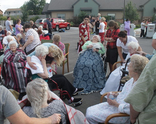Rick Egan  | The Salt Lake Tribune 

Residents of the Legacy Village care center in Kearns, wait in the parking lot as firefighters put out the fire, Monday, July 30, 2012. The residents were all moved safely into the parking lot while the firefighters put out the fire.