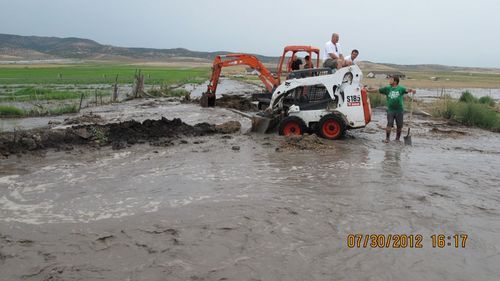 This photo tweeted by the Sanpte County Sheriff's Office shows  workers trying to divert water on July 30, 2012. A thunderstrom dropped water on the area burned in the Wood Hollow Fire.