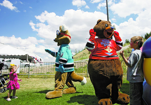 Kim Raff  |  The Salt Lake Tribune
Utah Olympic mascots Copper, left, and Coal visit with children during a London Summer Olympic celebration at Utah Olympic Park in Park City, Utah on July 28, 2012.