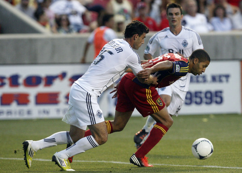 (The Salt Lake Tribune, Kim Raff) Real Salt Lake's Alvaro Saborio, right, shields the ball from Vancouver Whitecaps' Martin Bonjour during an MLS soccer game Friday at Rio Tinto Stadium. RSL opens CONCACAF Champions League play today at 8 p.m. (MDT).
