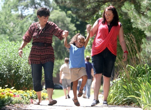 Rick Egan  |  The Salt Lake Tribune 
Becky Despain, left, swings daughter Josie Despain, along with Josie's birth mom, Jessalynn Speight, at a park in Ogden Friday, July 20, 2012.