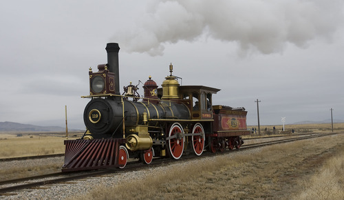 Tribune file photo
The Union Pacific steam locomotive 199 rolls down the track to the Golden Spike National Historic Site visitor center in northwestern Utah.