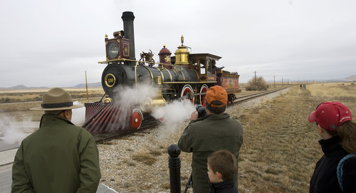 Tribune file photo
Folks gather for a picture of Union Pacific steam locomotive 199 as it rolls down the track to the Golden Spike National Historic Site visitor center in northwestern Utah.