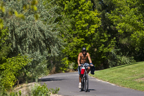Chris Detrick  |  The Salt Lake Tribune
A cyclist bikes Wednesday on the Jordan River Parkway Trail near Oxbow Park.  A complete map of the trail system has been designed and printed with the assistance of the National Park Service Rivers and Trails Conservation Assistance (RTCA) Program.