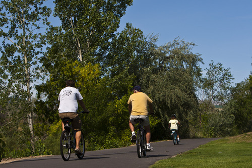 Chris Detrick  |  The Salt Lake Tribune
Cyclists bike on the Jordan River Parkway Trail near Oxbow Park Wednesday August 1, 2012.  A complete map of the Jordan River Parkway Trail system has been designed and printed with the assistance of the National Park Service Rivers and Trails Conservation Assistance (RTCA) Program.