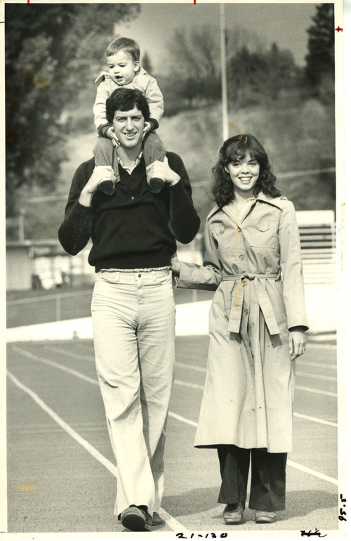 Tribune File Photo
Former BYU quarterback Marc Wilson carrying his son, Travis, with wife Colleen Wilson. 1979.