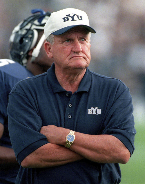 Tribune file photo
BYU Coach LaVell Edwards checks the clock during a game against the Washington Huskies in 1999.