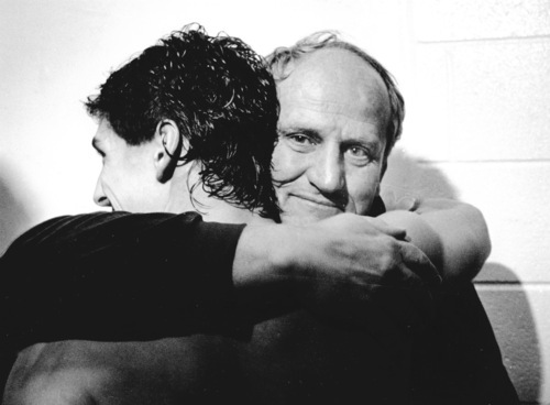 Coach Lavell Edwards gives Mark Bellini a hug after BYU's victory over Michigan in the 1984 Holiday Bowl in Jack Murphy Stadium in San Diego.  photo by RIck Egan 12/21/1984