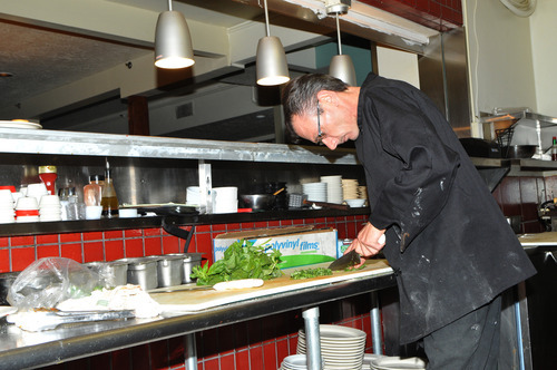 Bobby Robertson  |  for The Salt Lake Tribune
Head chef Francesco Montana chopping fresh basil for spaghetti pescadora in the kitchen of The Veranda.