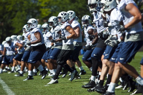 Chris Detrick  |  The Salt Lake Tribune
Members of the football team work out during a preseason practice at the BYU outdoor practice field Thursday August 2, 2012.