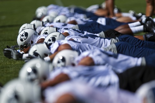 Chris Detrick  |  The Salt Lake Tribune
Members of the football team work out during a preseason practice at the BYU outdoor practice field Thursday August 2, 2012.