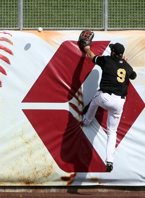 Kim Raff | The Salt Lake Tribune
Salt Lake Bees player Trevor Crowe climbs the wall but misses a fly ball hit by the Oklahoma City Redhawks at Spring Mobile Ballpark in Salt Lake City, Utah on August 5, 2012.