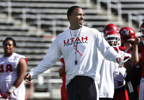 Scott Sommerdorf  |  The Salt Lake Tribune             
Utah Offensive Coordinator laughs with safties coach Morgan Scalley after the offense beat the defense on a play during Utah football team practice at Rice-Eccles Stadium, Thursday, April 19, 2012.