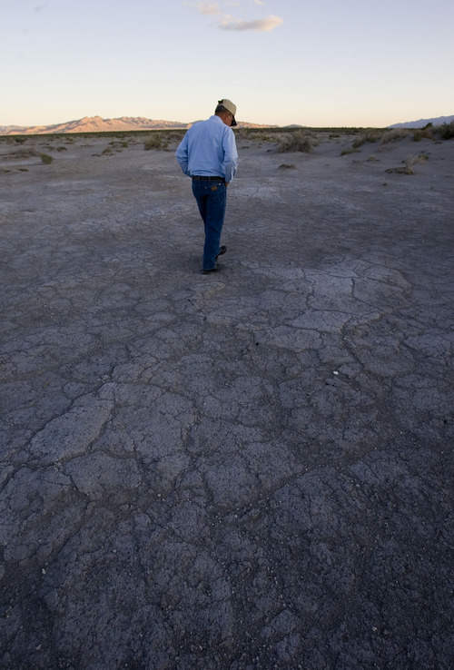 File  |  The Salt Lake Tribune
Rancher Dean Baker walks through what was once a lush meadow in search of fresh water snail shells in the Snake Valley in this 2008 photo.