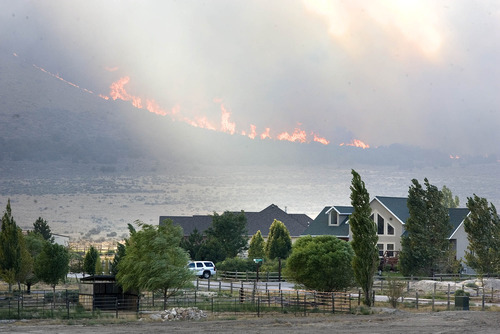 Paul Fraughton | Salt Lake Tribune
The  lightning caused  Pinion Fire burns behind homes in the North Ranch Subdivision in Eagle Mountain.
 Monday, August 6, 2012