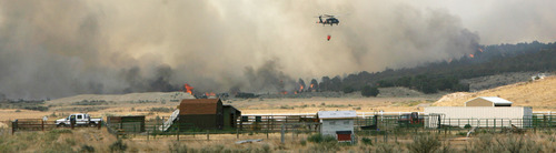 Steve Griffin | The Salt Lake Tribune


A helicopter flies above a burning ridge near Camp Williams and Eagle Mountain, Utah Monday August 6, 2012.