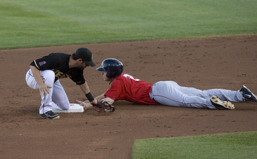 Kim Raff | The Salt Lake Tribune
Salt Lake Bees Matt Long is too late with the tag on Oklahoma City Redhawks player Brian Bixler as he steals second during a game at Spring Mobile Ballpark in Salt Lake City, Utah on August 6, 2012.