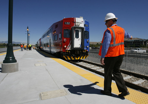 Francisco Kjolseth  |  Tribune file photo
Todd Provost, senior project manager and engineer for Project Delivery, guides the first FrontRunner train as it arrives in Utah County at the Lehi Station in June. The Salt Lake-to-Utah county line should be open for business in December -- at which time dozens of bus route changes will kick in.