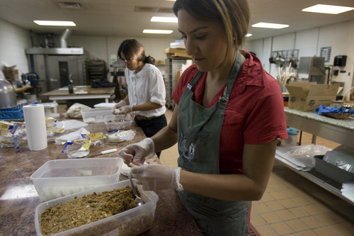 Kim Raff | The Salt Lake Tribune
Ana Valdemoros, whose company is Argentina's Best Empanadas, wraps beef empanadas in the kitchen of Martin's Fine Desserts in Salt Lake City on August 3, 2012.