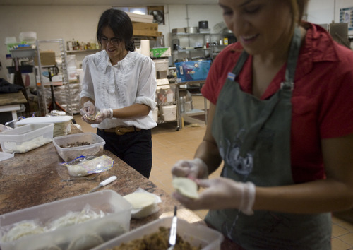 Kim Raff | The Salt Lake Tribune
Nichelle Jesen wraps empanadas in the kitchen of Martin's Fine Desserts in Salt Lake City, Utah on August 3, 2012.