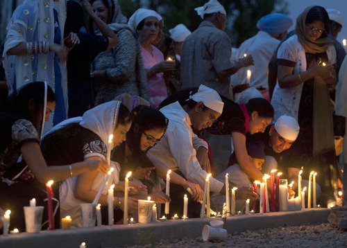 Steve Griffin | The Salt Lake Tribune


 Members of the Sikh Temple of Utah, place their candles outside the temple during a candlelight vigil for the victims of the shooting at the Wisconsin Sikh Temple. The service was at the temple in Taylorsville, Utah Wednesday August 8, 2012.