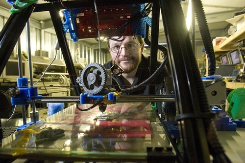 Paul Fraughton  |  The Salt Lake Tribune
Tim Anderson watches as his 3-D printer, following a computer-generated design, deposits layer after layer of plastic on a glass panel to create a three dimensional  copy.