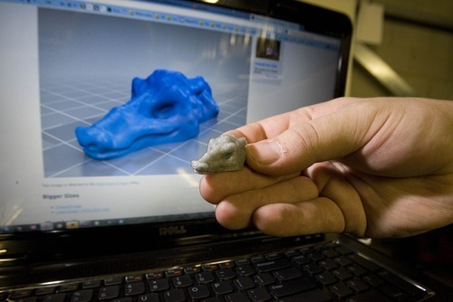 Paul Fraughton | The Salt Lake Tribune
Tim Anderson holds a dragon's head that was created via his 3-D printer. The machine deposits layer after layer of plastic to create a finished project.