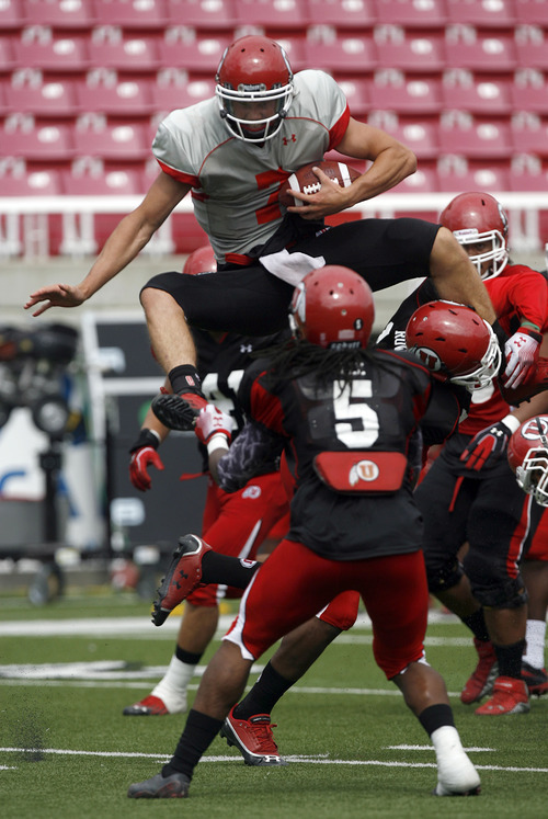 Francisco Kjolseth  |  The Salt Lake Tribune
Quarterback Travis Wilson tries to hurdle himself over the opposition as the University of Utah football team gets ready for the season with a scrimmage game at Rice-Eccles stadium on Friday, August 10, 2012.
