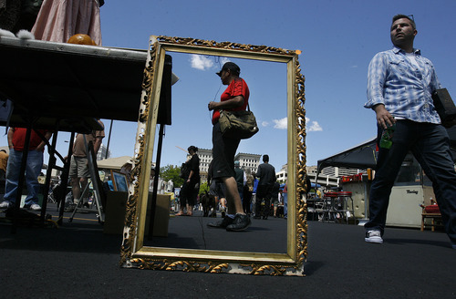 Scott Sommerdorf  |  Tribune file photo             
Shoppers are framed in an old frame for sale at the Urban Flea Market in Salt Lake City in June. The marketplace is open the second Sunday of every month through October at 400 S. State St.