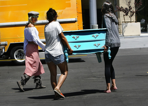 Scott Sommerdorf  |  Tribune file photo             
Buyers carry off their found treasures at the opening day of the Urban Flea Market in Salt Lake City in June. The marketplace is open the second Sunday of every month through October at 400 S. State St.