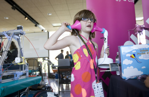 Kim Raff | The Salt Lake Tribune
At the Leonardo's booth Gigi Earnest-Stippich plays with telephone in the Xmission's Science and Technology Building DIY Engineers display during the 4th annual Craft Lake City Utah's DIY Festival at the Gallivan Center in Salt Lake City, Utah on August 11, 2012.