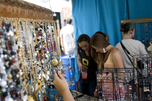 Kim Raff | The Salt Lake Tribune
People look at jewelry in April Wearable Art's booth during the 4th annual Craft Lake City Utah's DIY Festival at the Gallivan Center in Salt Lake City, Utah on August 11, 2012.