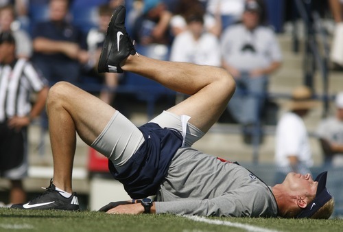 Rick Egan  | The Salt Lake Tribune 

BYU head coach Bronco Mendenhall stretches out with the team, before the scrimmage at LaVell Edwards StadiumThursday, August 9, 2012.